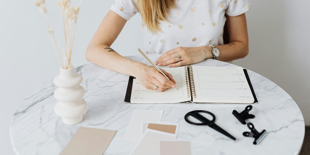 Event Planner at Table with Notebook and Color Swatches